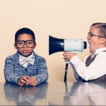 Kid with megaphone pointed at another kid